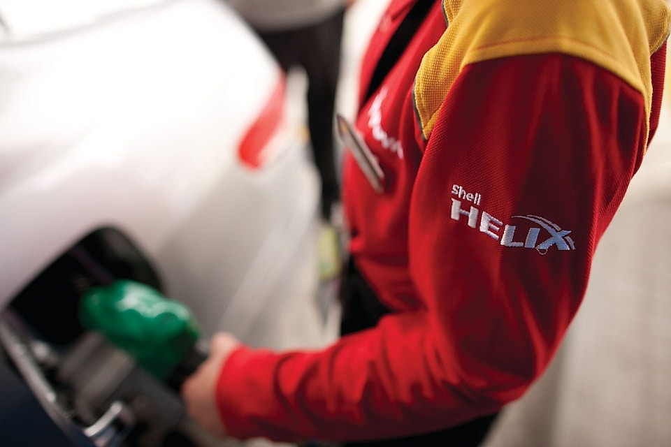 A man filling Shell fuel in the car