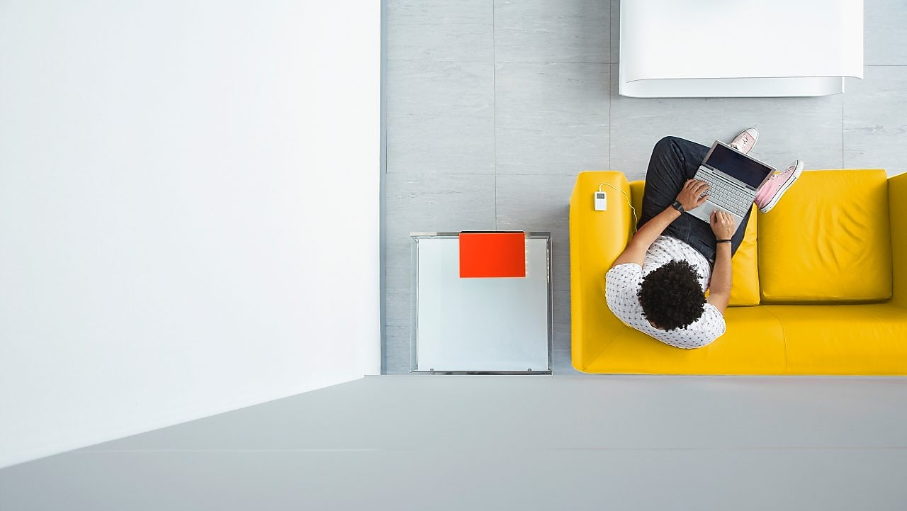 Person relaxing on a sofa in the office
