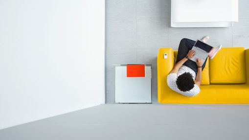 Person relaxing on a sofa in the office