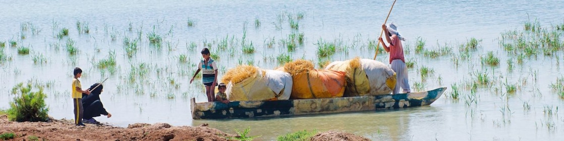 Local people cross the flooded Hawizeh Marshes, near the Majnoon project in Iraq