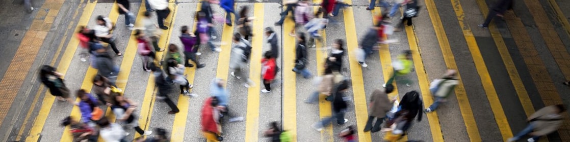 People cross a busy street in Hong Kong