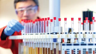 A man focused on his task inside a laboratory.